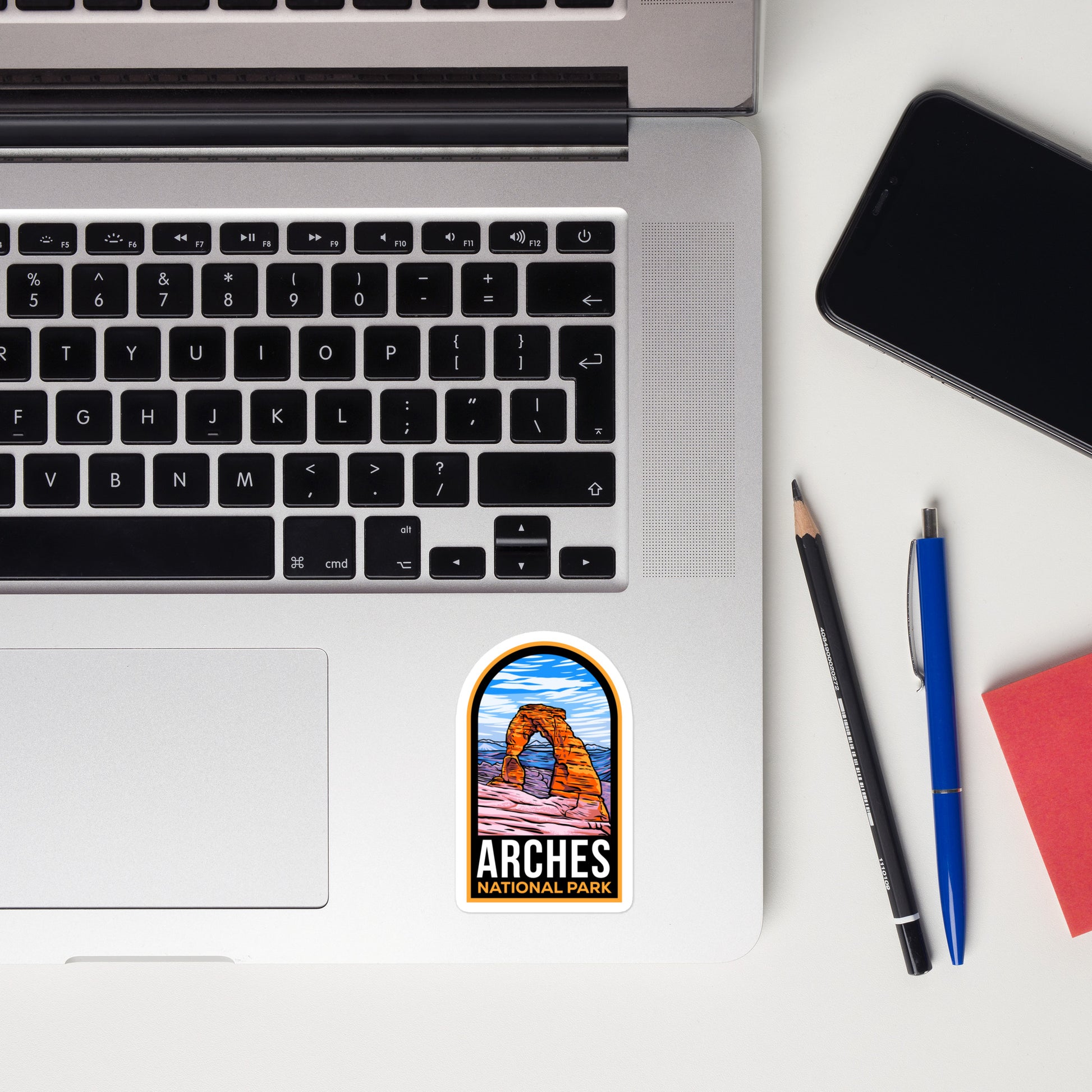 A sticker of Arches National Park on a laptop