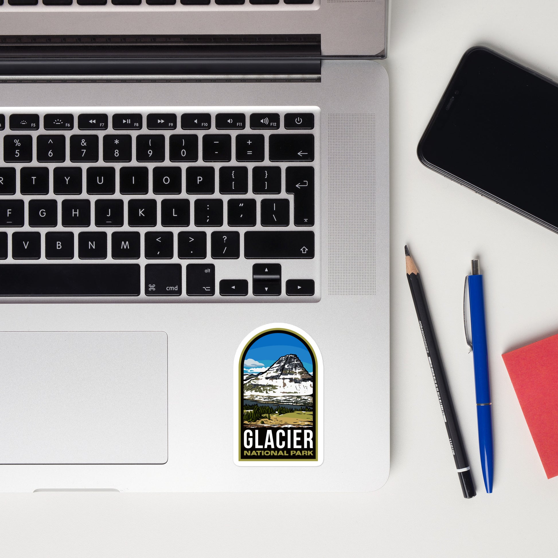 A sticker of Glacier National Park on a laptop