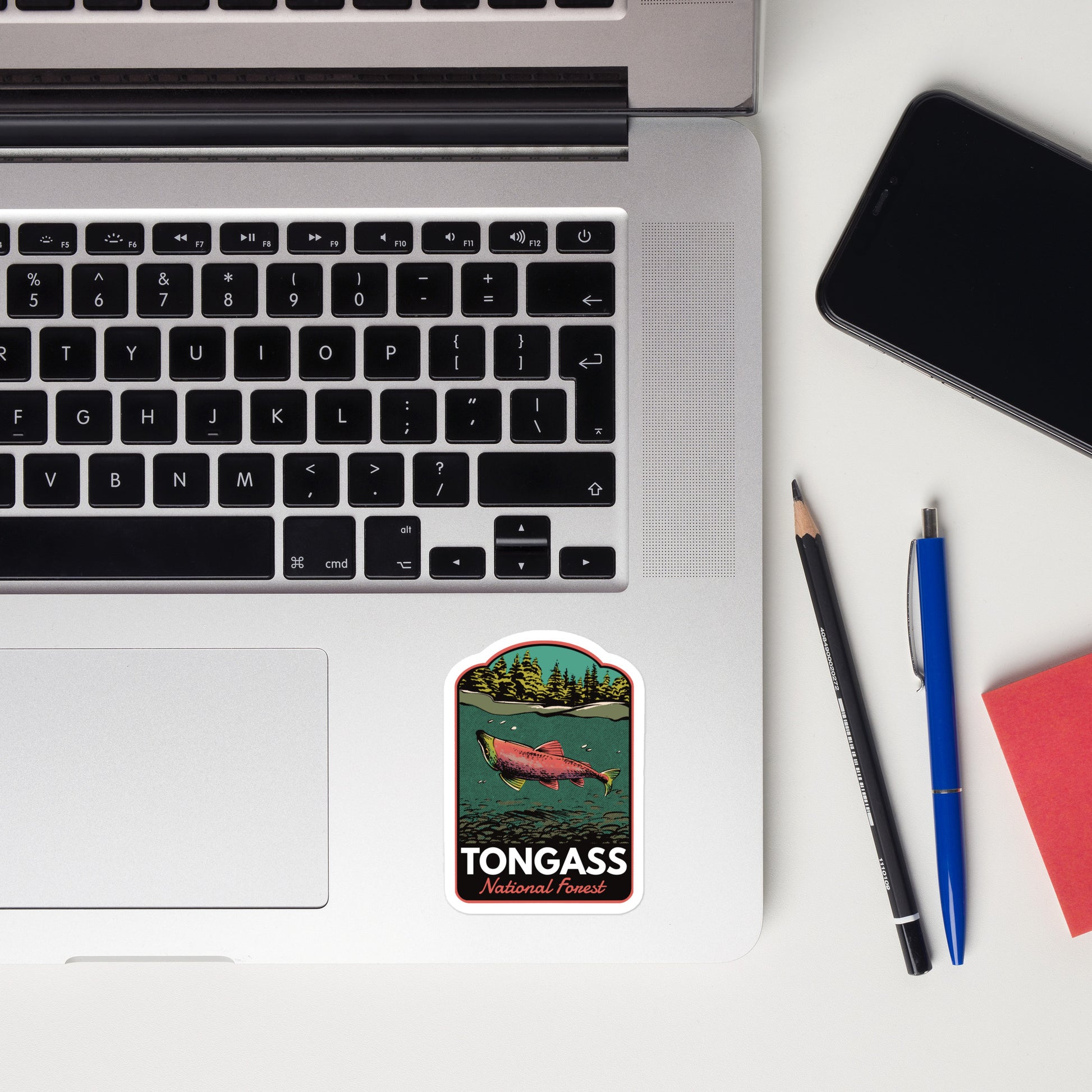 A sticker of Tongass National Forest on a laptop